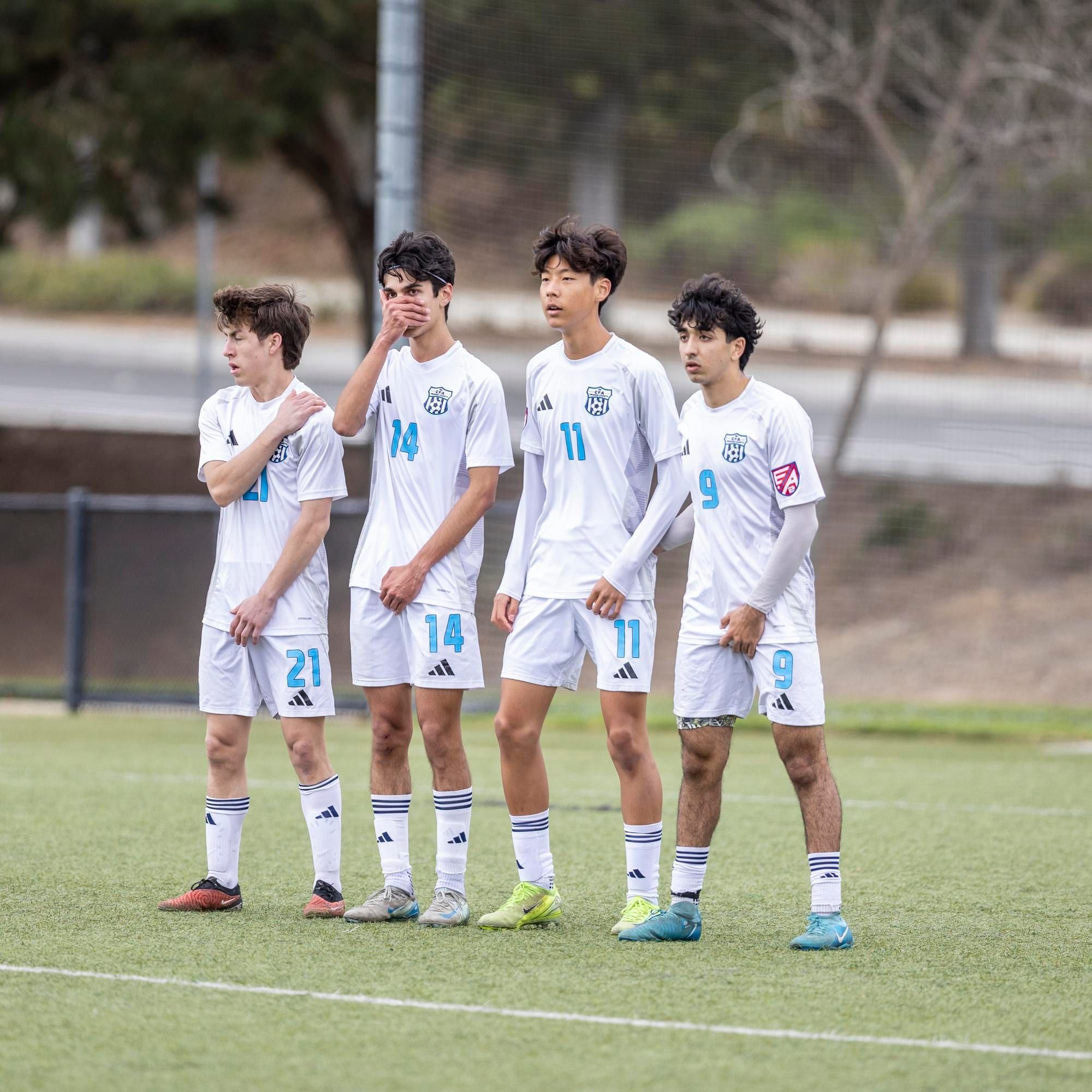 CFA boys in white lined up in a free-kick wall