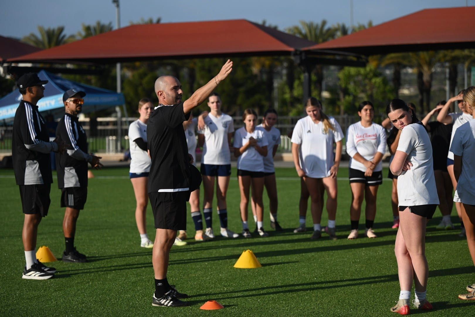 CFA coach giving instructions to a group of players