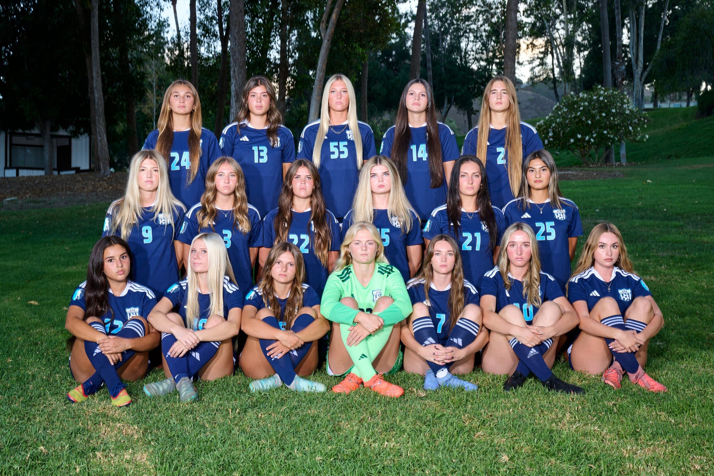 CFA girls squad in navy kits posing for a team photo