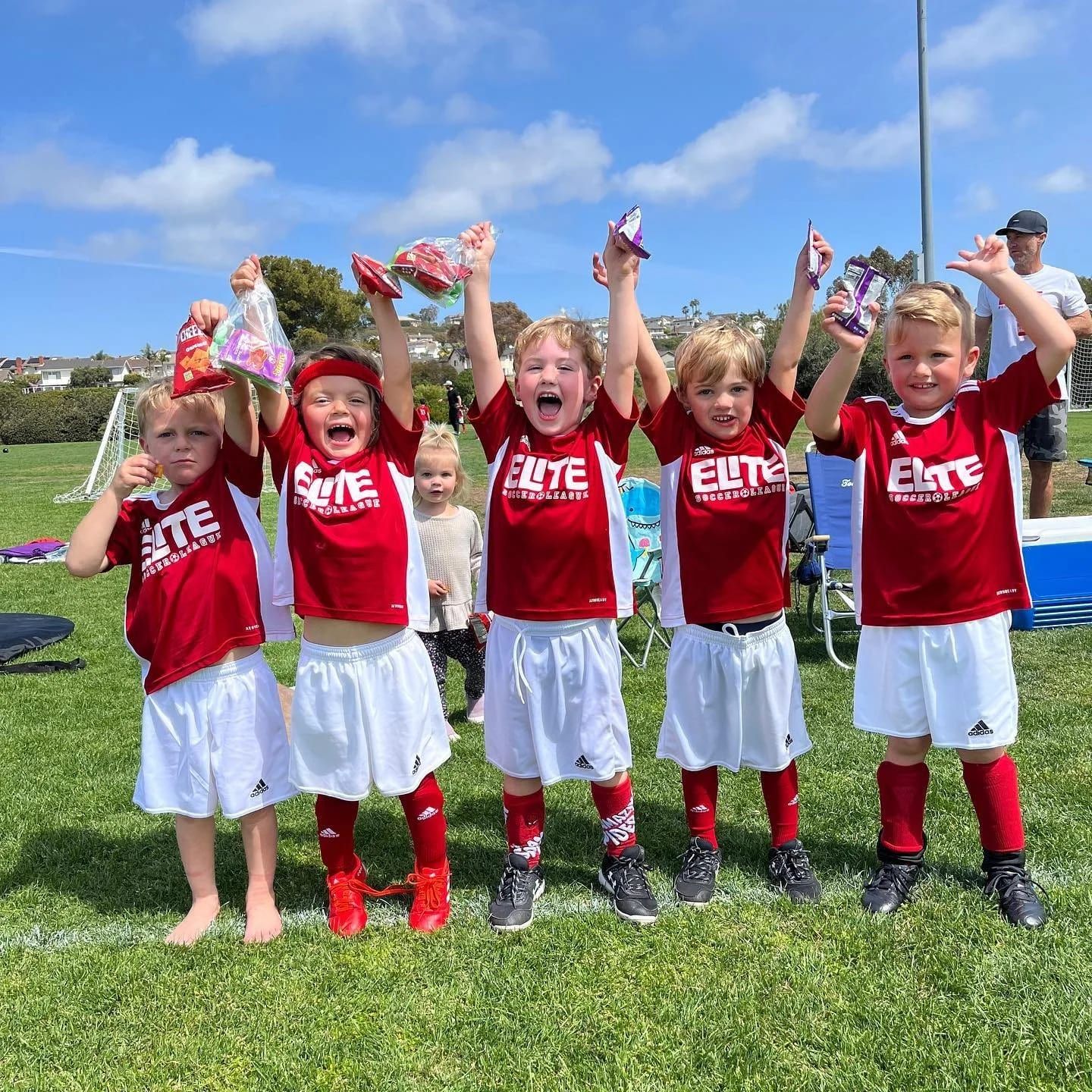 Elite Soccer League rec team in red cheering after a game
