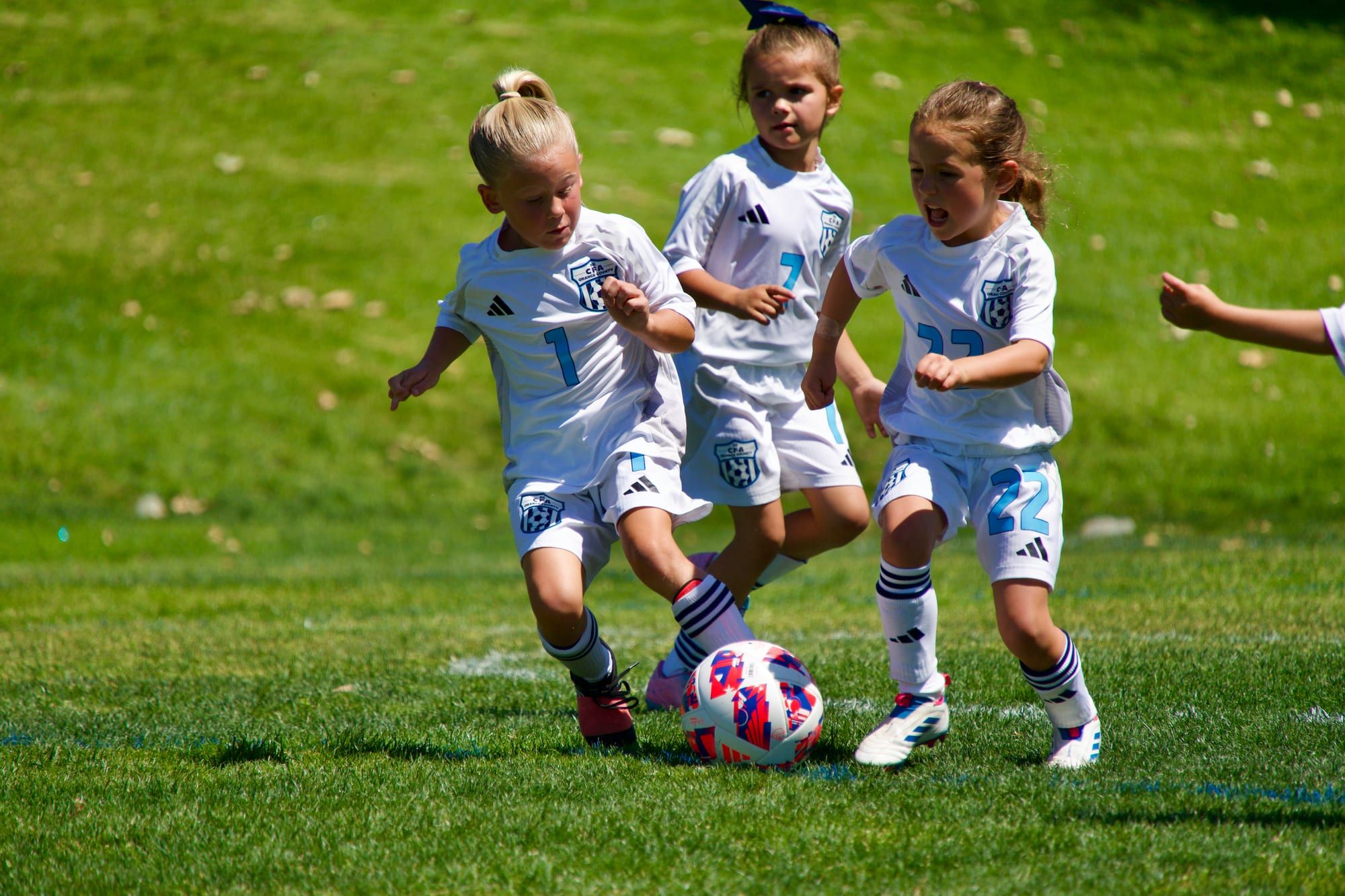 Young players chasing the ball together in a small-sided game